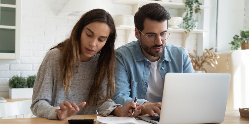 Serious,Man,And,Woman,Calculating,Bills,,Using,Calculator,And,Laptop,