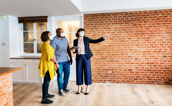 Real,Estate,Agent,And,Customer,In,Face,Mask,Looking,At