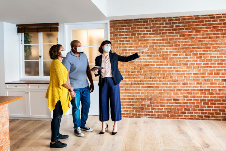 Real,Estate,Agent,And,Customer,In,Face,Mask,Looking,At