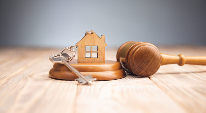 Judge,Gavel,And,House,Key,On,Wooden,Background.,Estate,Law