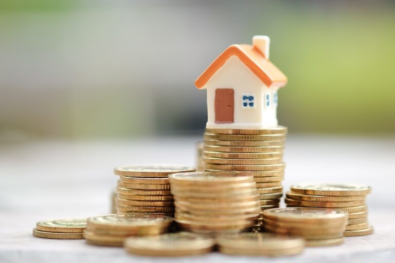 Mini,House,On,Stack,Of,Coins.,Concept,Of,Investment,Property.